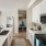 Kitchen with stainless steel appliances and Flat panel light grey cabinets