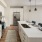 Kitchen with a bar window opened up to living and dining spaces 